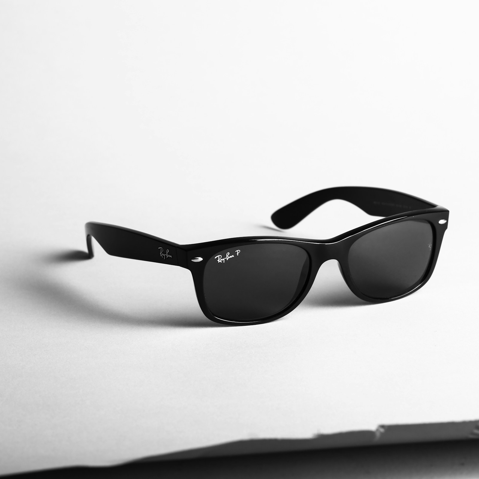 Minimalist titanium spectacle frames on dark volcanic stone